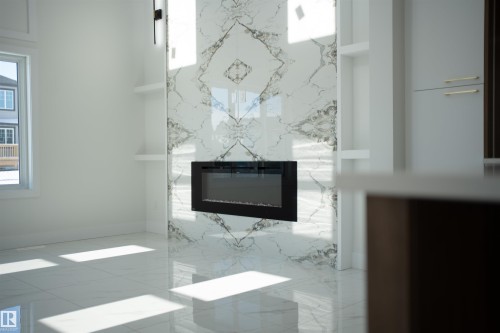 Detailed view of a fireplace and baseboards - 4006 40 Street, Beaumont, AB - Indoor Photo Showing Other Room With Fireplace