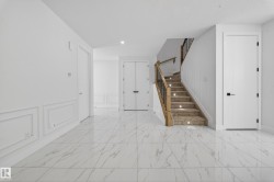 Staircase with a decorative wall, wainscoting, and recessed lighting - 