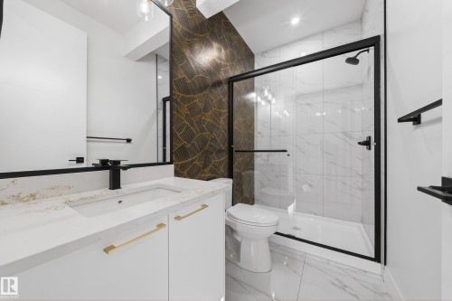 Full bath with light marble finish flooring, vanity, a marble finish shower, recessed lighting, and stone wall - 4006 40 Street, Beaumont, AB - Indoor Photo Showing Bathroom