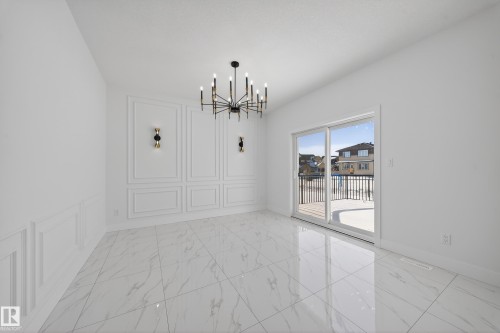 Unfurnished dining area with hanging lights and a decorative wall - 4006 40 Street, Beaumont, AB - Indoor Photo Showing Other Room