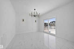 Unfurnished dining area with hanging lights and a decorative wall - 