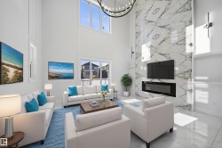 Living room with suspended lighting, marble tiled floors, a fireplace, and a high ceiling - 