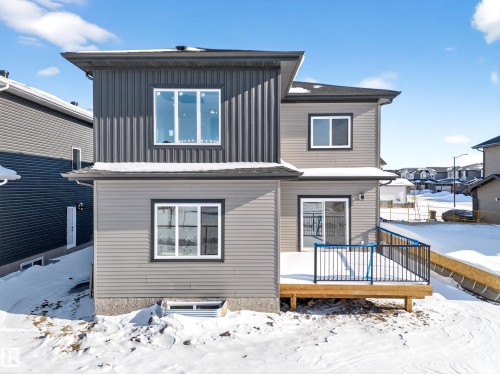 Snow covered back of property featuring a deck - 4006 40 Street, Beaumont, AB - Outdoor With Exterior