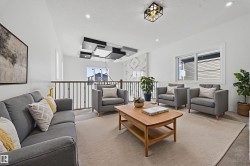 Carpeted living area with recessed lighting - 