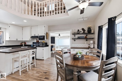 Dining space with a ceiling fan, light wood-style flooring, recessed lighting, and a high ceiling - 4919 50 Avenue, Bon Accord, AB - Indoor Photo Showing Other Room