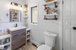 Half bathroom with vanity and tasteful backsplash - 