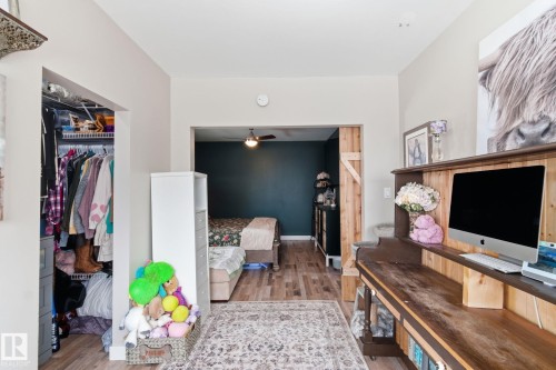 Bedroom with light wood-type flooring and a closet - 4919 50 Avenue, Bon Accord, AB - Indoor