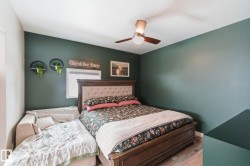 Bedroom featuring wood finished floors and a ceiling fan - 