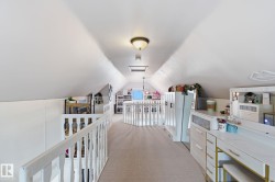 Hallway featuring light carpet - 