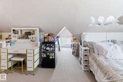 Bedroom featuring light colored carpet and vaulted ceiling - 