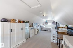 Bedroom with light carpet and attic access - 