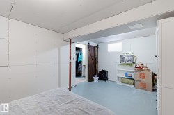 basement with finished concrete floors and a barn door - 