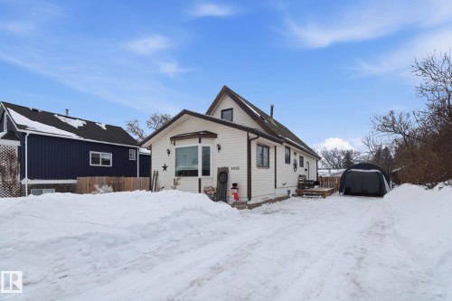 View of front of home featuring a wooden deck and an outbuilding - 4919 50 Avenue, Bon Accord, AB - Outdoor