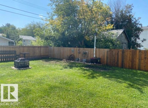 Fenced backyard with a fire pit - 4919 50 Avenue, Bon Accord, AB - Outdoor