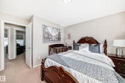Bedroom featuring light colored carpet and baseboards - 