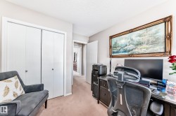 Office area featuring light colored carpet and a textured ceiling - 