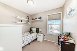 Bedroom with baseboards and light colored carpet - 