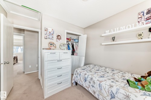 Bedroom with light colored carpet and a closet - 14043 151 Avenue, Edmonton, AB - Indoor Photo Showing Bedroom