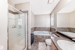 Full bathroom with vanity, a shower stall, a textured ceiling, a bath, and tile patterned floors - 