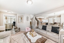 Living room with stairs and baseboards - 