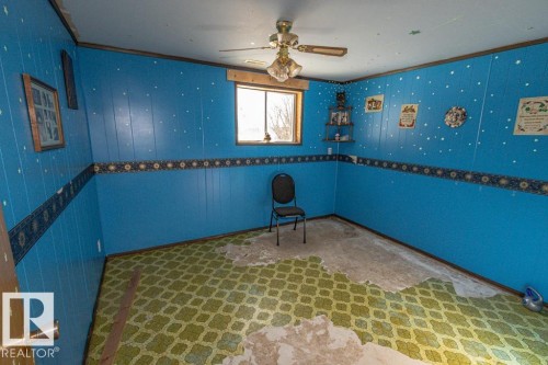 Interior space with ceiling fan, crown molding, and unfinished concrete flooring - 11126 Twp Rd 605A, Rural St. Paul County, AB - Indoor Photo Showing Other Room