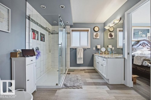 Ensuite bathroom featuring vanity, light wood-style floors, a stall shower, and recessed lighting - 3011 44A Street, Edmonton, AB - Indoor