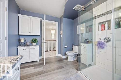 Bathroom with vanity, a stall shower, and light wood-type flooring - 3011 44A Street, Edmonton, AB - Indoor Photo Showing Bathroom