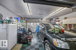 Garage featuring freestanding refrigerator and a garage door opener - 