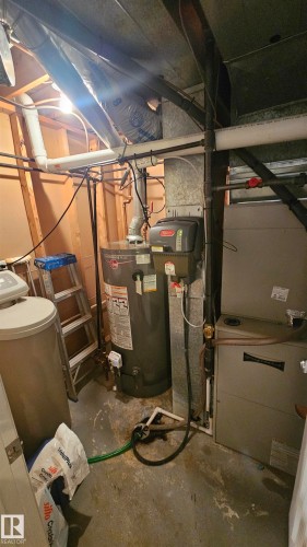 Utilities featuring gas water heater and heating unit - 3011 44A Street, Edmonton, AB - Indoor Photo Showing Basement