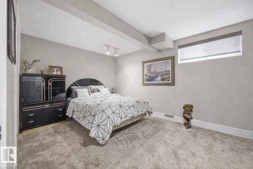 Carpeted bedroom featuring track lighting and baseboards - 3011 44A Street, Edmonton, AB - Indoor Photo Showing Bedroom
