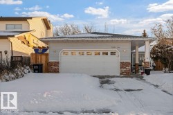 View of front of house with brick siding and a garage - 