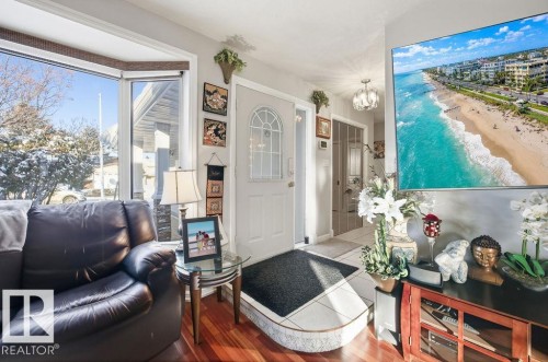 Living room with a chandelier and wood finished floors - 3011 44A Street, Edmonton, AB - Indoor