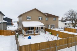 Back of house featuring a fenced backyard and a deck - 