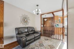 Living room with a chandelier and parquet flooring - 