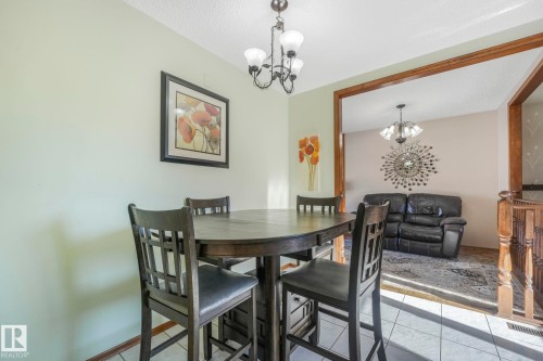 Dining room featuring a chandelier, light tile patterned floors, and a textured ceiling - 760 Knottwood Road S, Edmonton, AB - Indoor Photo Showing Dining Room