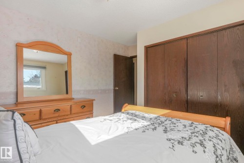 Bedroom featuring wainscoting and a closet - 760 Knottwood Road S, Edmonton, AB - Indoor Photo Showing Bedroom