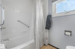 Full bath featuring shower / tub combo with curtain and toilet - 