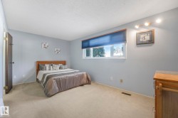 Bedroom with carpet and a textured ceiling - 