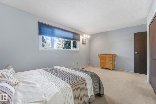 Bedroom featuring carpet floors and a textured ceiling - 760 Knottwood Road S, Edmonton, AB - Indoor Photo Showing Bedroom