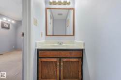 Bathroom featuring vanity, a textured ceiling, and carpet - 