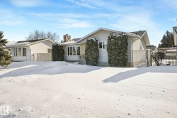 View of front of home with a gate and a chimney - 