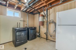 Laundry area with tile patterned floors and washer and dryer - 