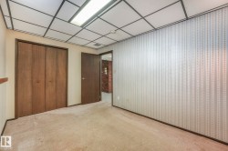 Unfurnished bedroom featuring a paneled ceiling, carpet flooring, and a closet - 