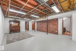 Finished basement featuring brick wall - 