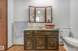Half bath with vanity and parquet flooring - 