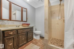 Bathroom featuring a stall shower and vanity - 