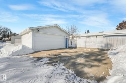 Snow covered garage with a detached garage - 