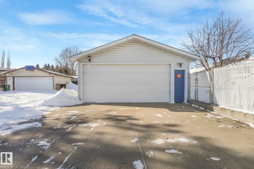 Snow covered garage with a garage - 760 Knottwood Road S, Edmonton, AB - Outdoor