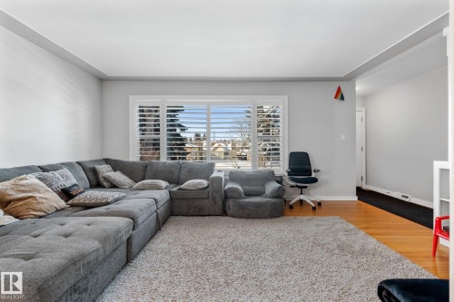 Living area featuring light wood finished floors and baseboards - 9847 79 Street, Edmonton, AB - Indoor Photo Showing Living Room