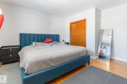 Bedroom featuring wood finished floors and a closet - 